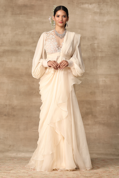 RM-Ivory embroidered net-chiffon peplum with exaggerated sleeves paired with chiffon-organza draped ruffle saree.